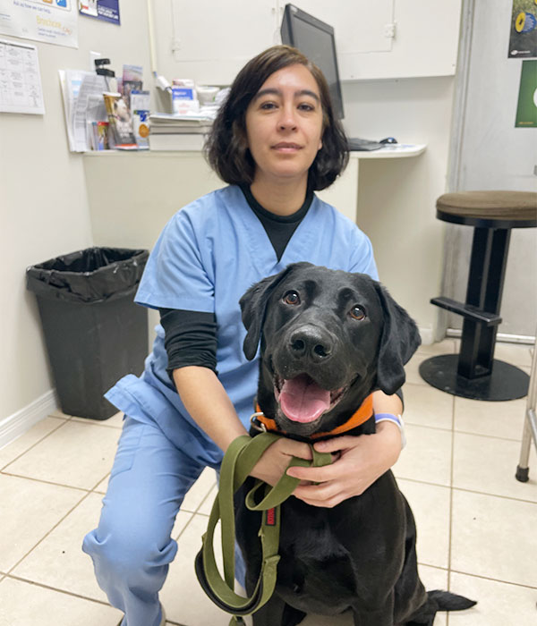 Dr. Alejandra Melgoza sitting and holding dog